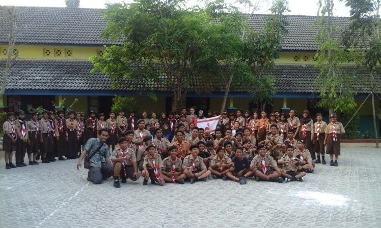 A nice group picture of the Scouts, boys and girls alike, after the birthday celebration. Note the splatter of flour on the ground in the front.