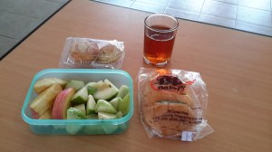 My usual breakfast of a pandan custard bun and fruit, plus the hot tea and packet of snacks (one sweet and one savory) that always mysteriously appears on my desk.