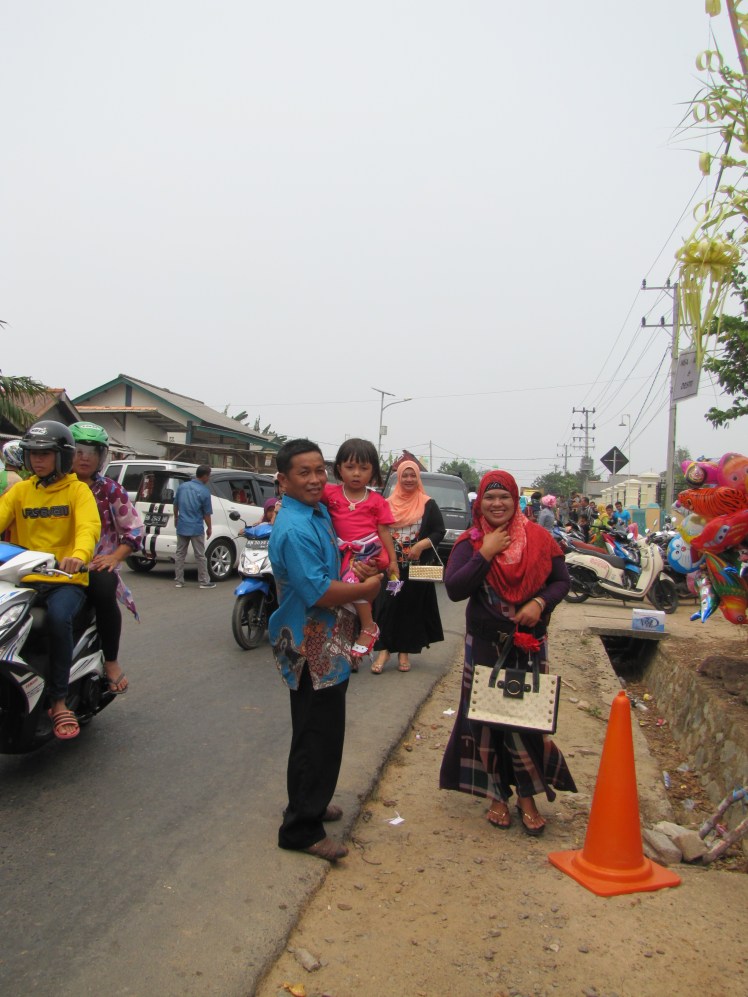 A family wanted me to take their picture as they arrived at the wedding. Notice the traffic jam in the background. I have seen many others weddings set up right in the middle of the street here, which can be a minor inconvenience for motorists but is just part of life here.