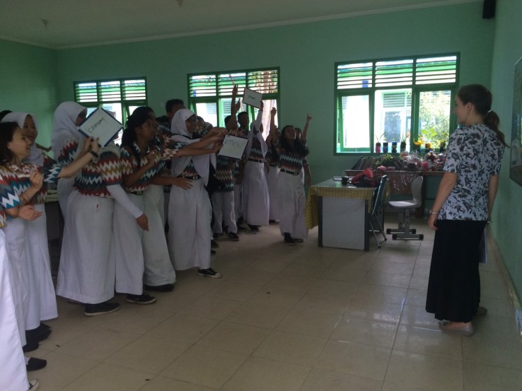Miss Kelly trying to figure out which group raised their board first. In the case of a tie, everyone got points. (Otherwise there might have been a mutiny.)