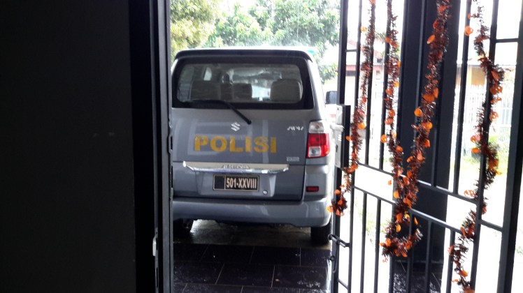 This police car belongs to Manggo's uncle and he was picking us up to go to a party, not to take us to jail. Still, I thought it was a funny picture to have a police car parked outside our door. The neighbors were full of questions afterward.