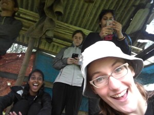 Hiding from the rain in a farmer's pondok.